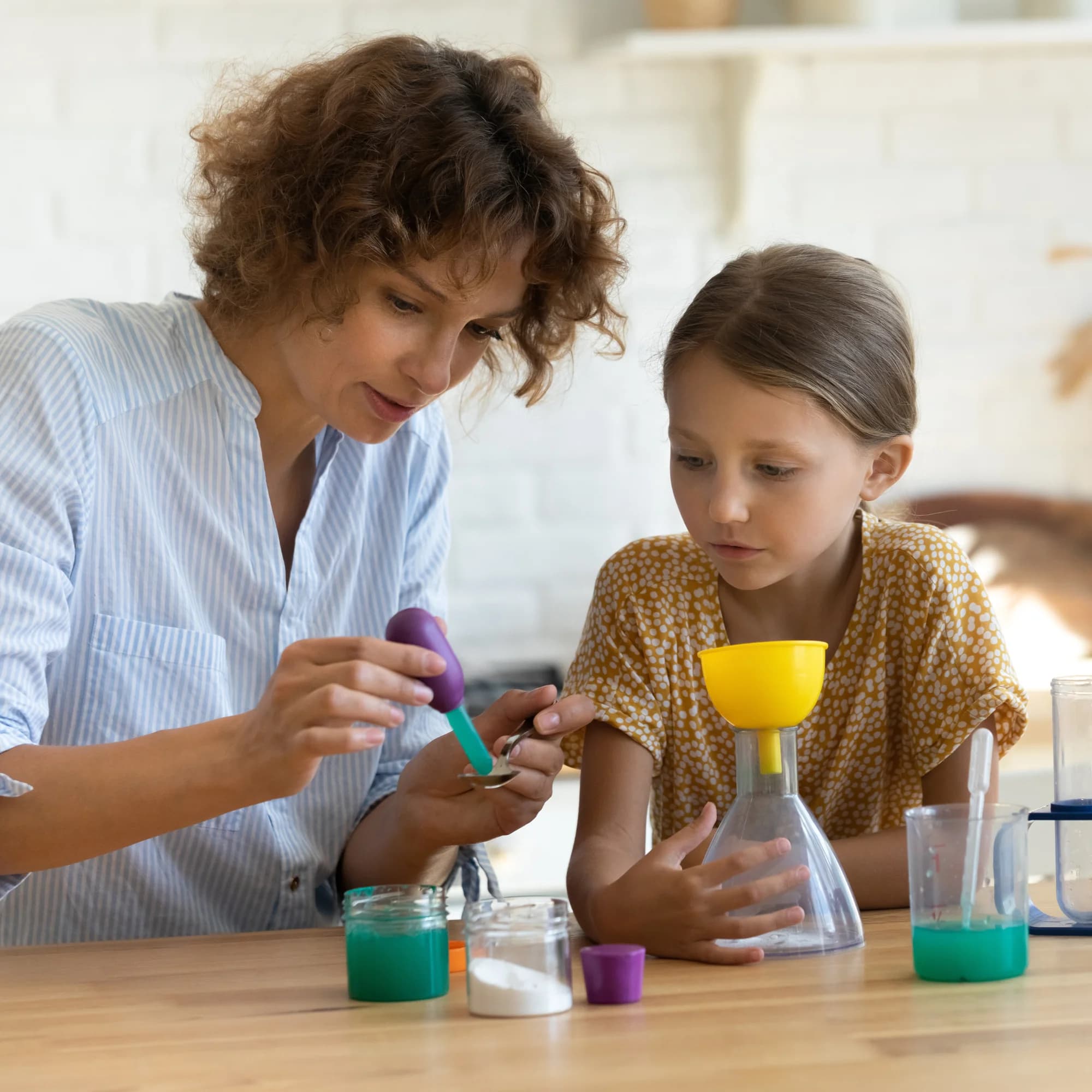 Educator guiding a learner through a hands-on science activity